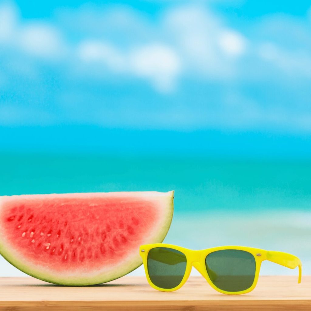 Watermelon and sunglasses on a summer beach