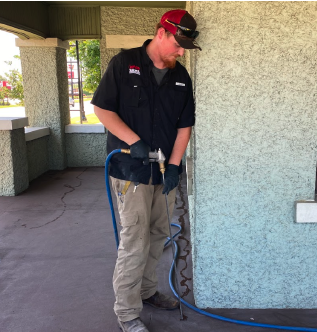 Bama technician applying a liquid termite treatment