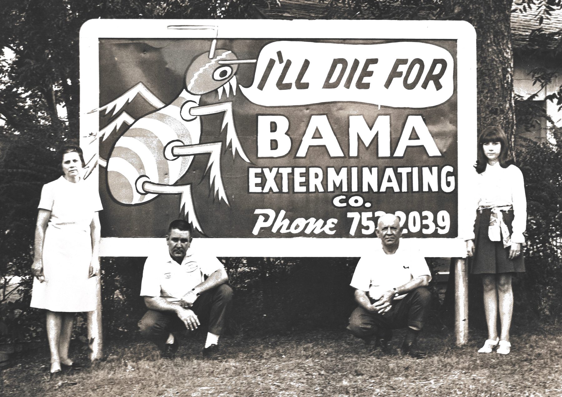 Bama family and staff with the I'll Die For Bama billboard
