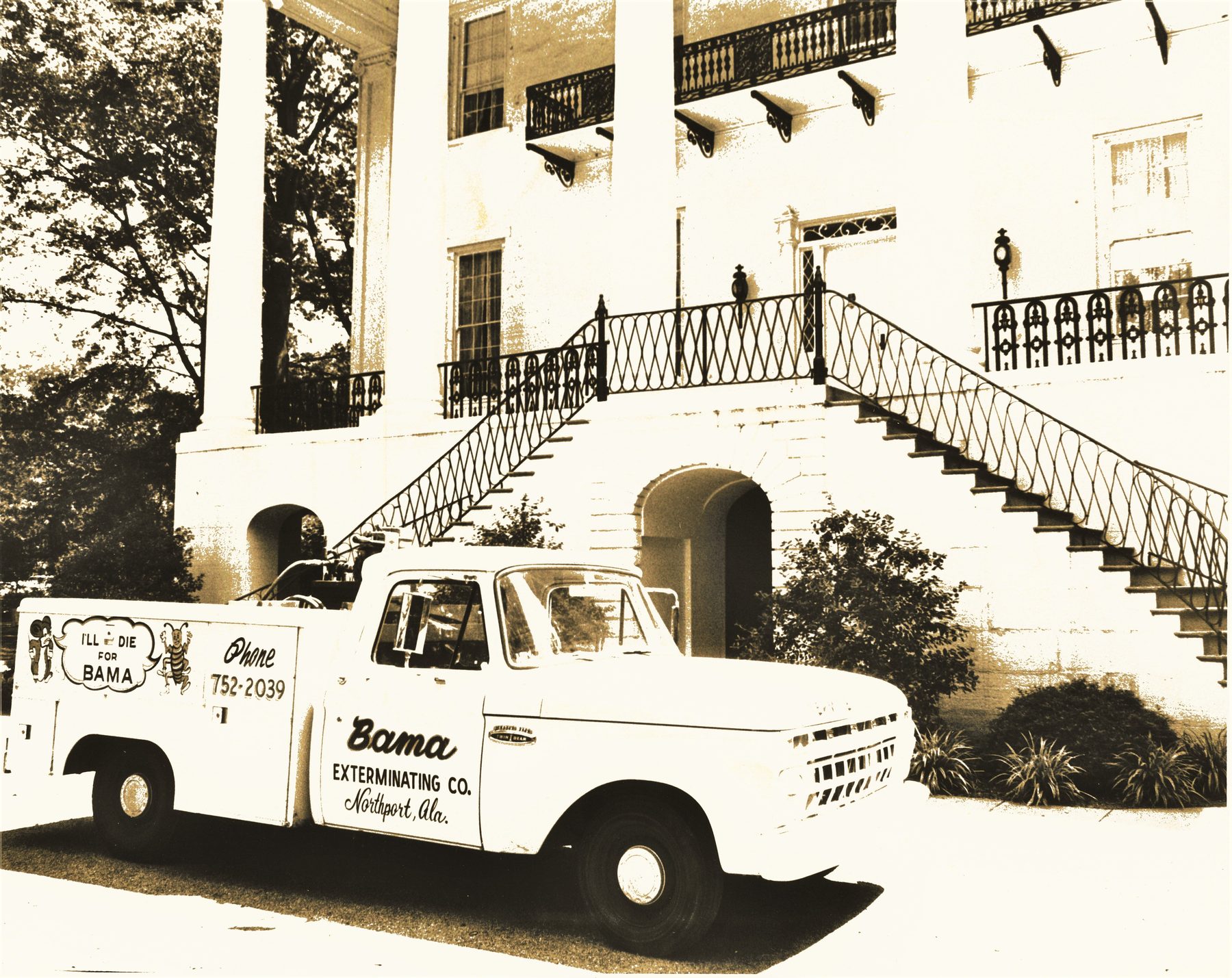 Vintage Bama Exterminating truck in front of a historic Alabama home